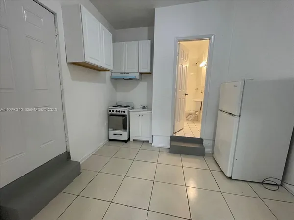 a kitchen with stainless steel appliances a refrigerator and a stove top oven