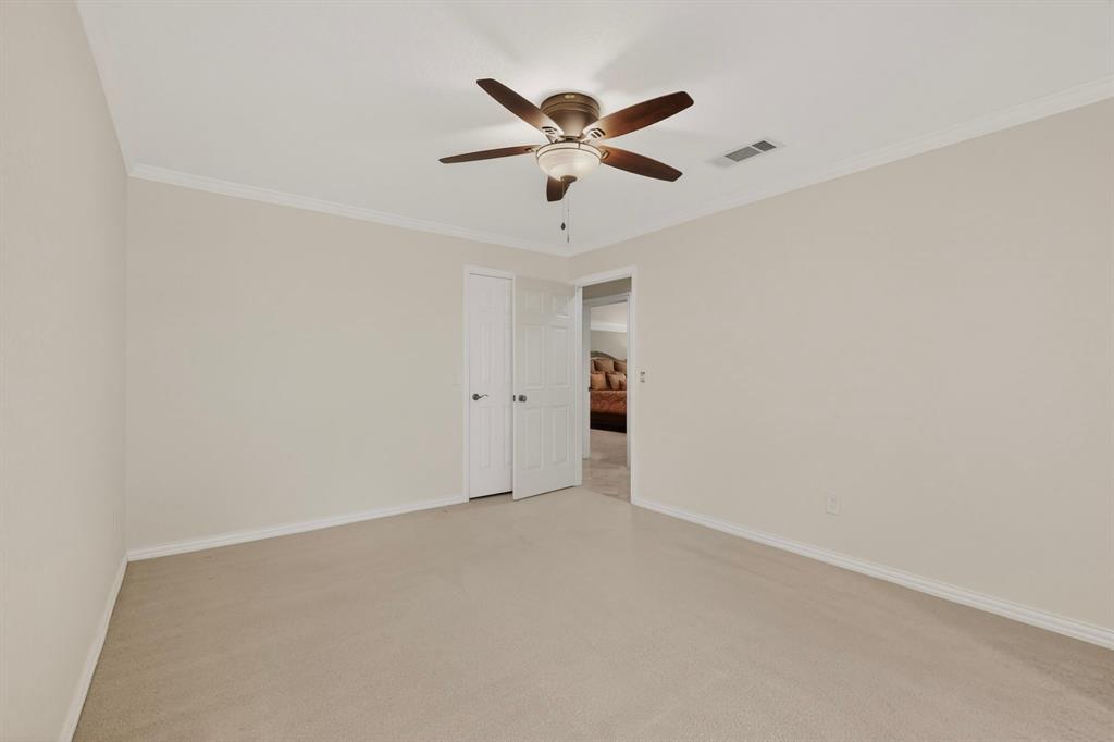 2405 Wing Point Lane Plano, TX 75093 - Photo 30 of 39 an empty room with window and ceiling fan