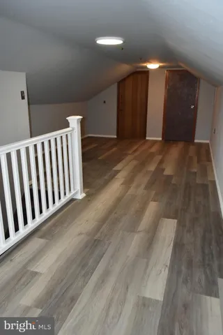 an empty room with wooden floor