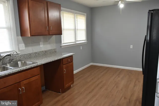 a kitchen with granite countertop wooden cabinets and a granite counter tops