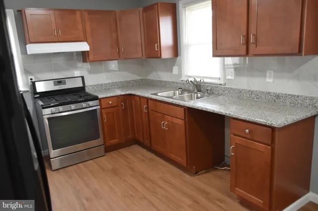 a kitchen with a sink stove and cabinets