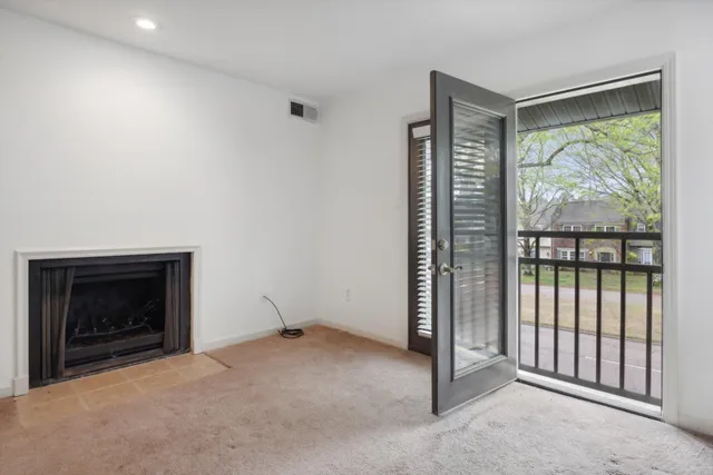 a kitchen with granite countertop a refrigerator a sink and white cabinets