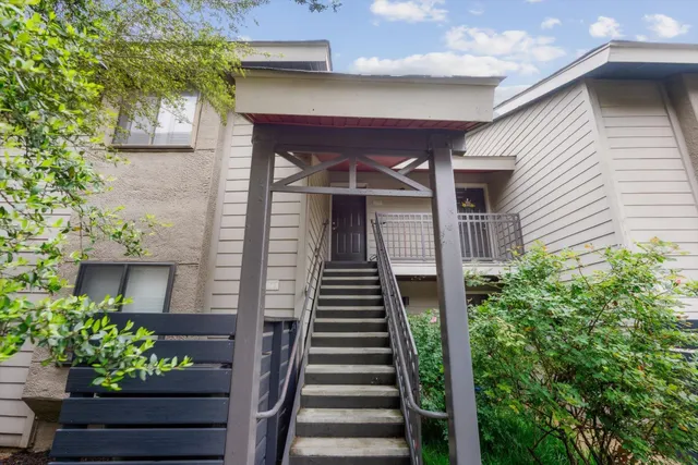 a front view of a house with plants