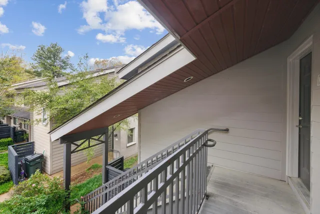 a view of balcony with wooden floor and fence