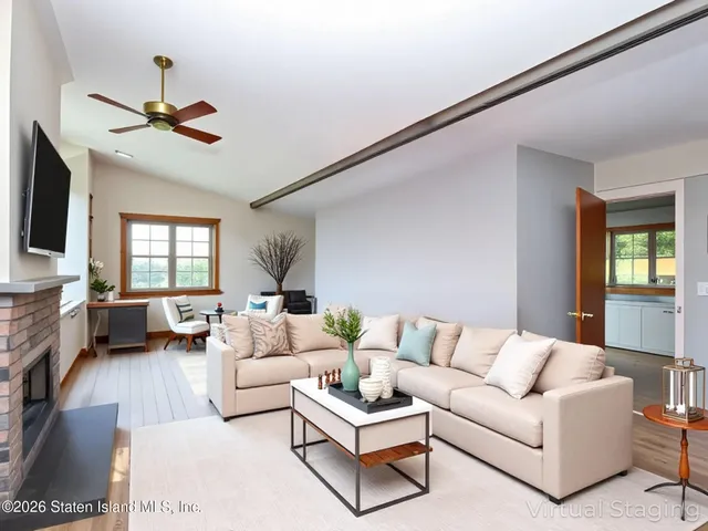 a living room with furniture or couch and a flat screen tv