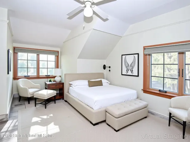 a bedroom with a bed and a large window