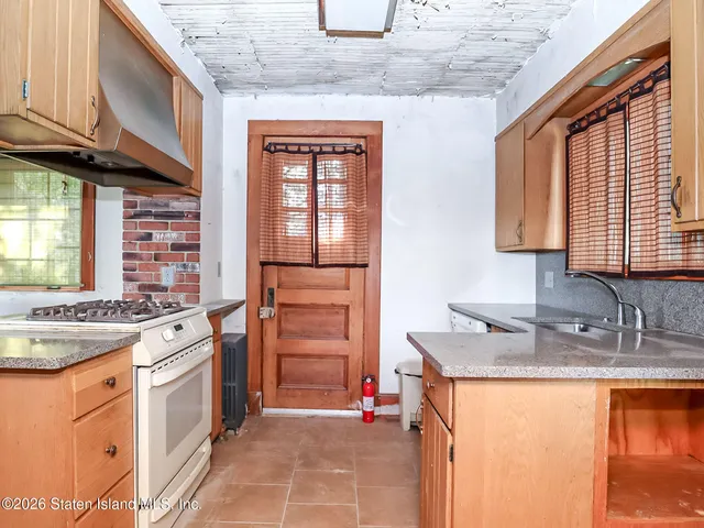 a kitchen with stainless steel appliances granite countertop a stove sink and cabinets