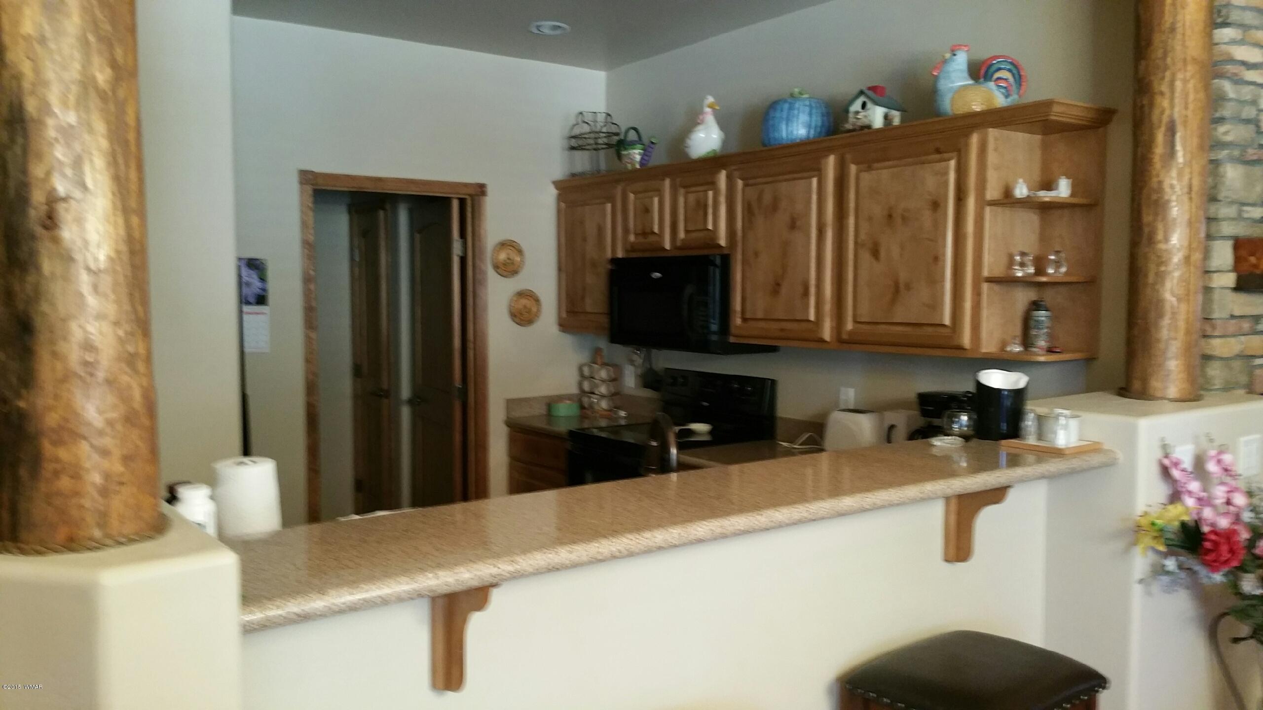 2831 West Villa Loop, Unit 102 Show Low, AZ 85901 - Photo 3 of 6 a kitchen with stainless steel appliances a sink a refrigerator and a microwave