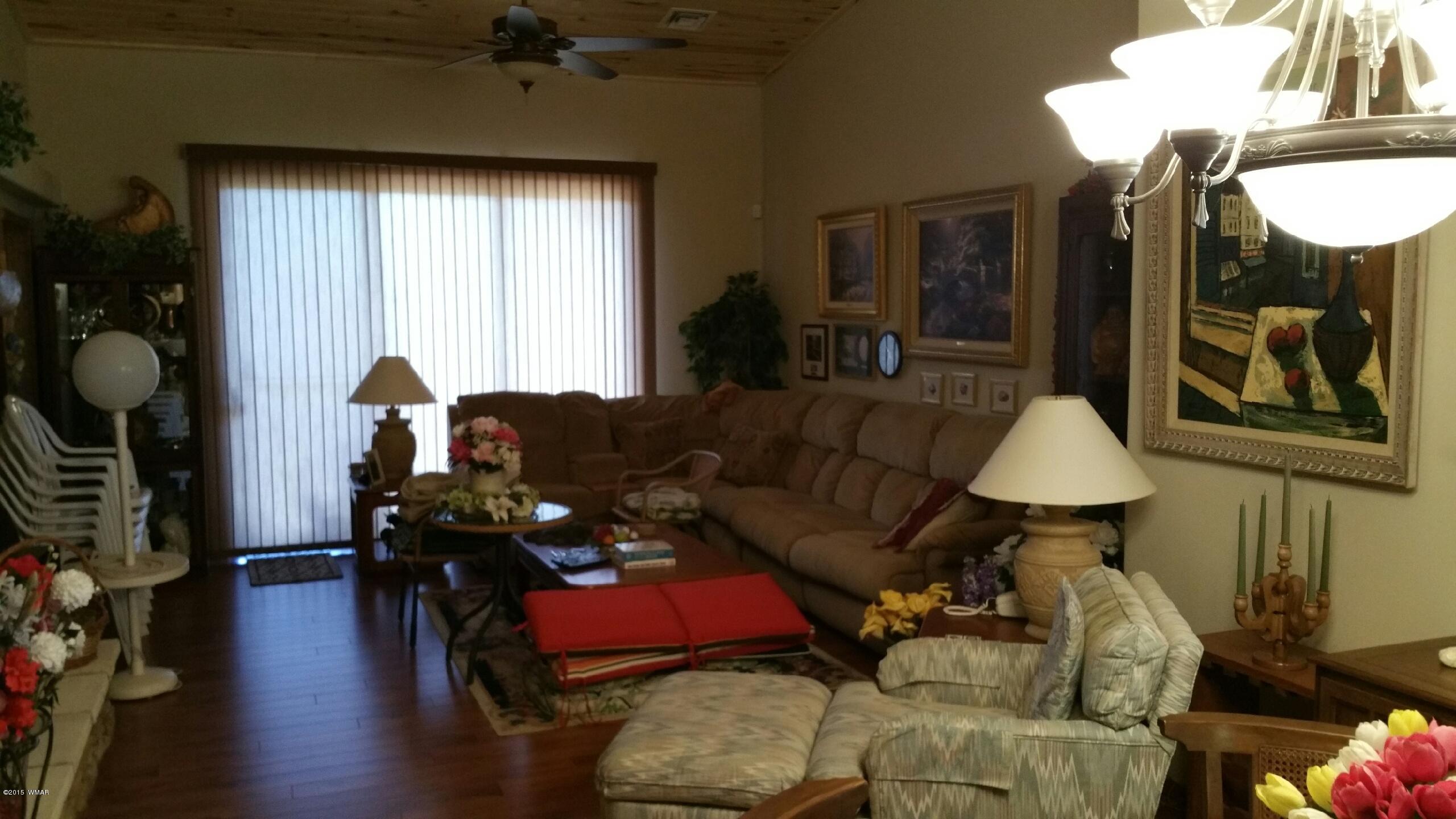 2831 West Villa Loop, Unit 102 Show Low, AZ 85901 - Photo 5 of 6 a living room with furniture and wooden floor