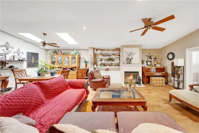 a living room with furniture kitchen view and a large window