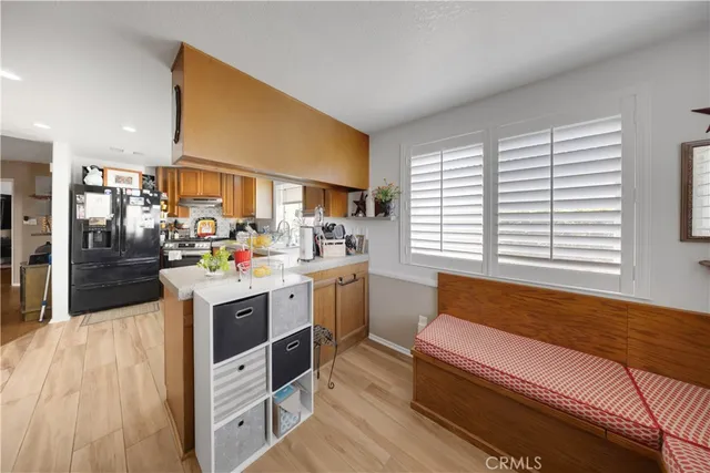 a kitchen with a sink appliances cabinets and furniture