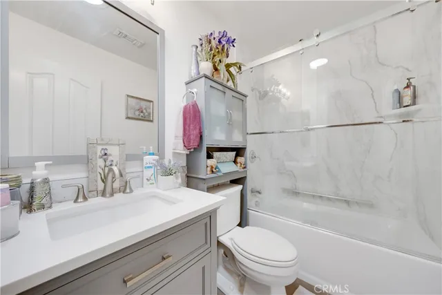 a spacious bathroom with a double vanity sink a mirror and a bathtub