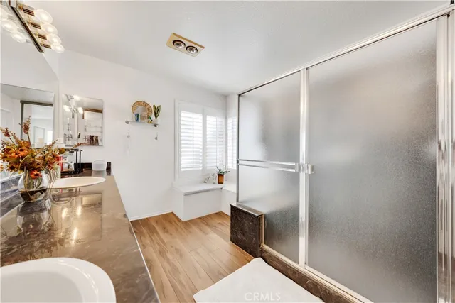 a bed room with a bed mirror and a dresser