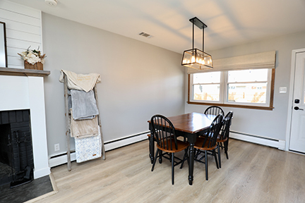 100 Lee Street Manhattan, IL 60442 - Photo 9 of 21 a dining room with wooden floor a chandelier a wooden table and chairs