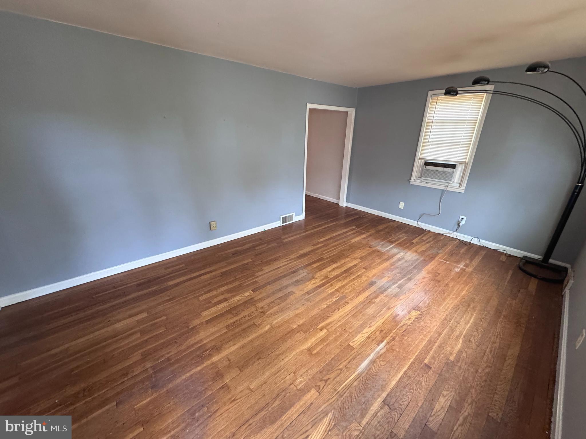 1705 Summit Avenue Baltimore, MD 21227 - Photo 3 of 7 a view of a room with wooden floor and white walls
