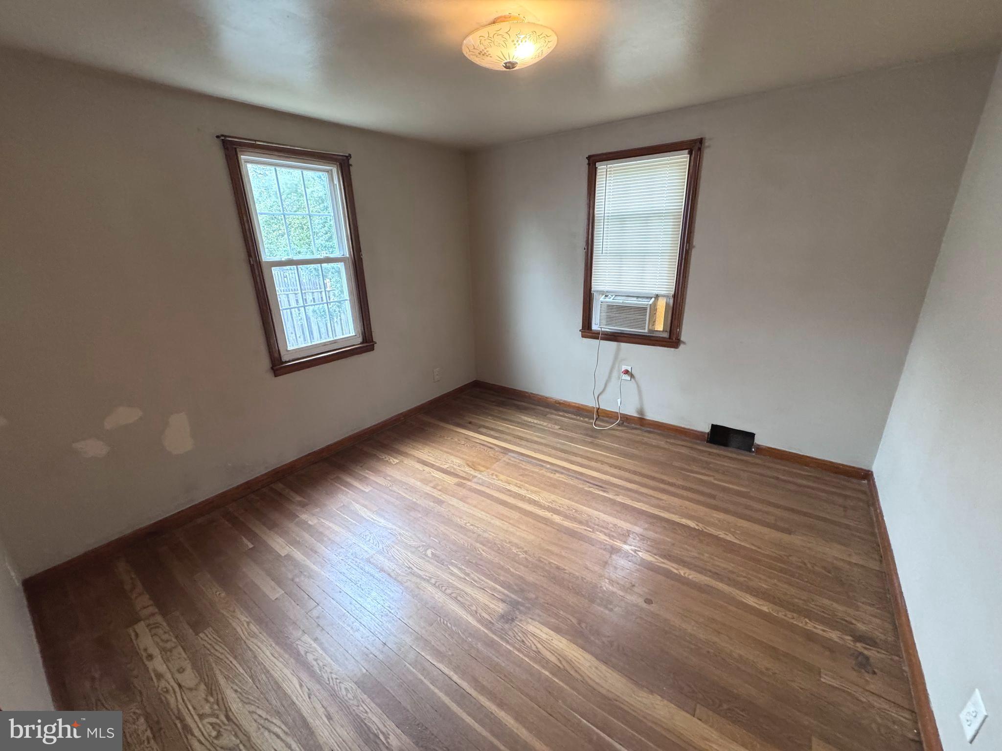 1705 Summit Avenue Baltimore, MD 21227 - Photo 6 of 7 a view of empty room with wooden floor and fan