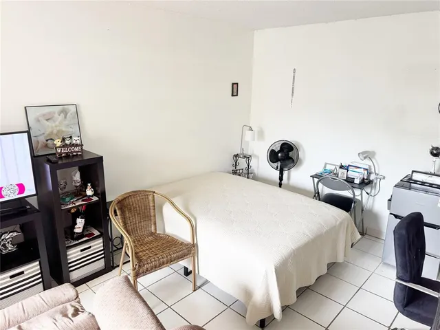 a bedroom with bed and chair