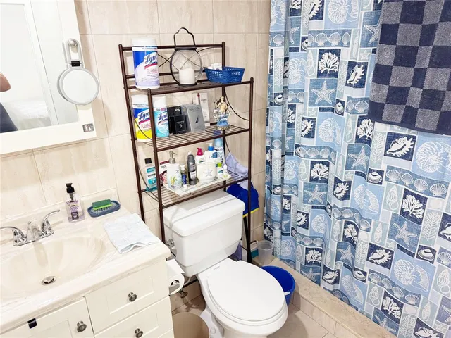 a white toilet sitting next to a bathroom sink