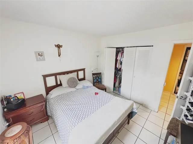 a bed room with a bed and a mirror