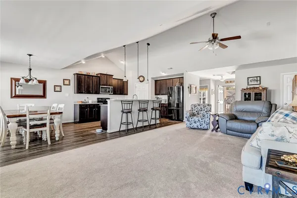 a large white kitchen with furniture and a flat screen tv