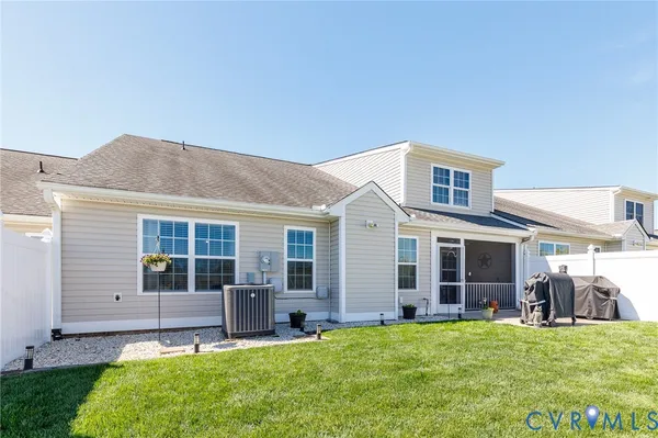a backyard of a house with yard table and chairs
