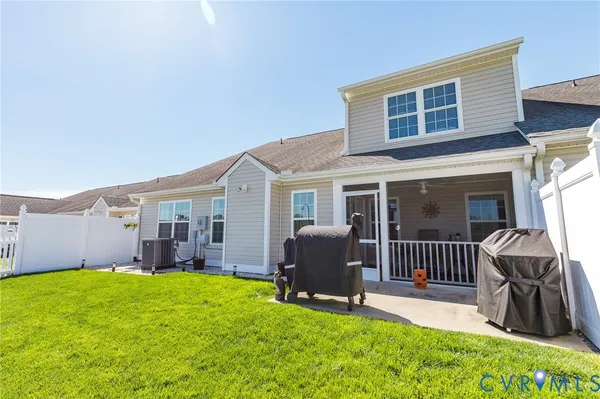 a view of a house with a yard and deck