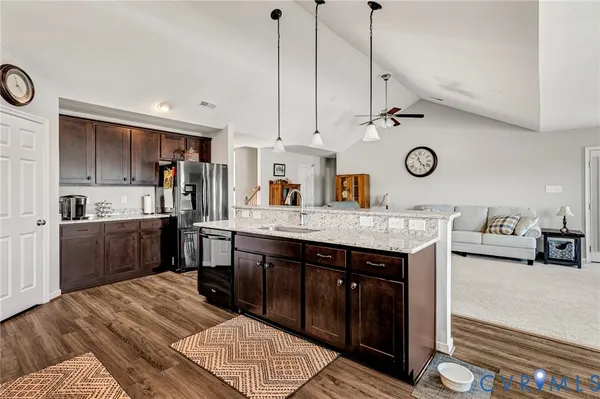 a kitchen with a sink appliances and cabinets