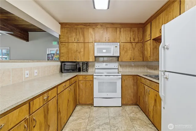 a kitchen with a refrigerator sink and stove