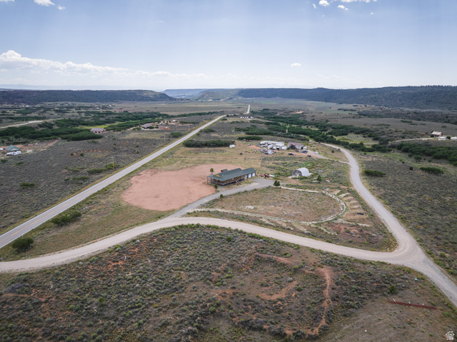 1 Tobe Day Road La Sal, UT 84530 - Photo 19 of 67 Expansive rural landscape featuring a central property with multiple structures, including a primary residence with a dark roof and an outbuilding