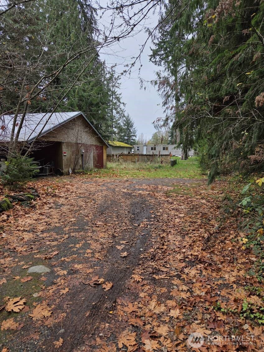 15820 62nd Avenue Northwest Gig Harbor, WA 98332 - Photo 6 of 7 a big house with a big yard and large trees