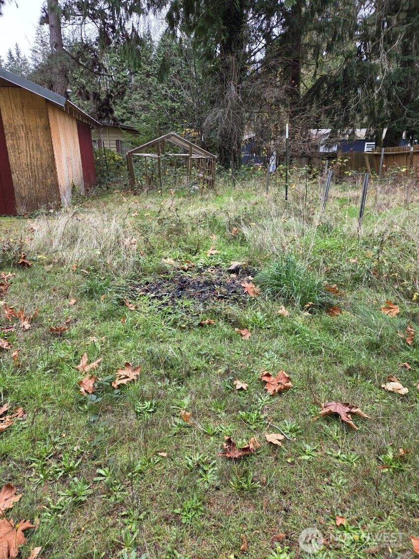 15820 62nd Avenue Northwest Gig Harbor, WA 98332 - Photo 7 of 7 a backyard of a house with lots of green space and a fountain