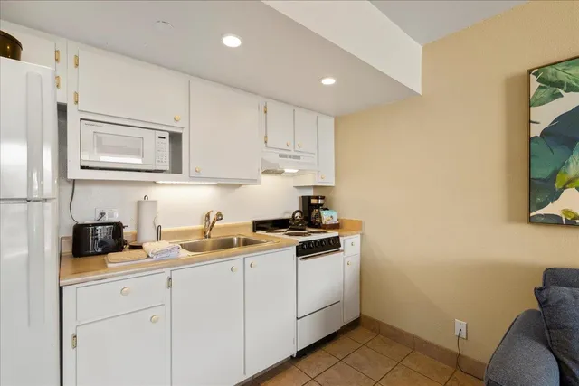 a kitchen with a sink cabinets and stainless steel appliances
