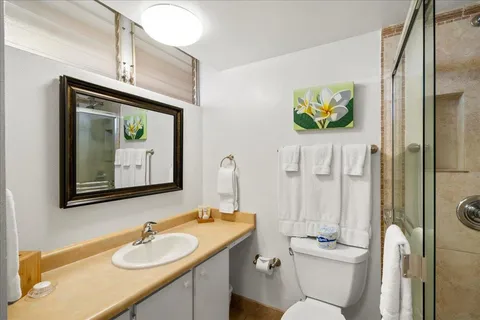 a bathroom with a toilet a sink and mirror