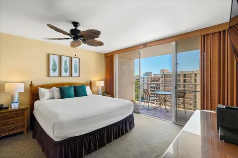 a bedroom with a large bed and a chandelier