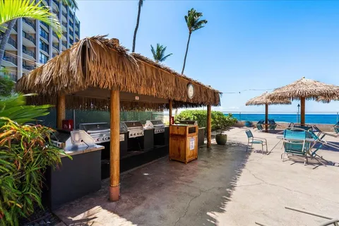 a view of a tables and chairs under an umbrella in the patio
