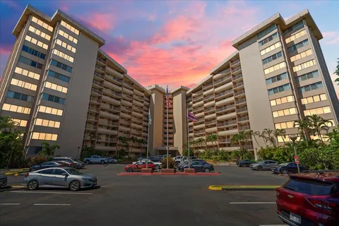 a city street lined with parked cars and buildings