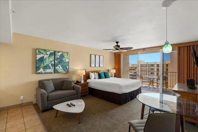 a bedroom with furniture and a large window