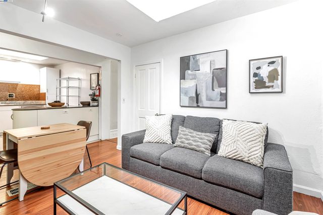 a living room with furniture and kitchen view
