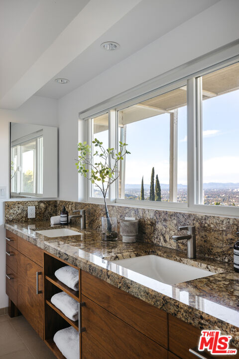 3272 Wrightwood Drive Studio City, CA 91604 - Photo 19 of 36 a bathroom with a granite countertop sink and a large mirror