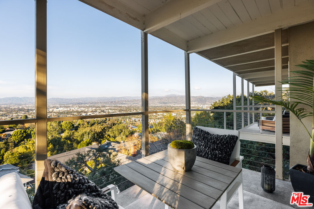 3272 Wrightwood Drive Studio City, CA 91604 - Photo 29 of 36 an outdoor living room with patio furniture and a floor to ceiling window