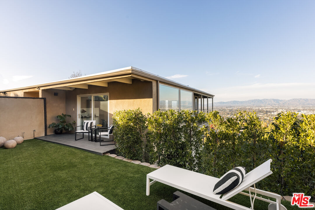 3272 Wrightwood Drive Studio City, CA 91604 - Photo 31 of 36 a backyard of a house with table and chairs