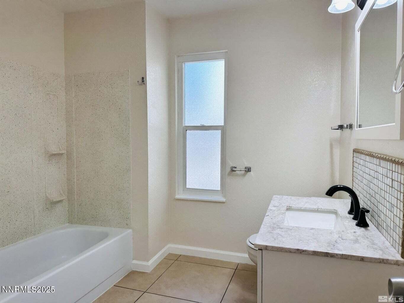 3927 Clear Acre Lane, Unit 207 Reno, NV 89512 - Photo 12 of 33 a bathroom with a granite countertop sink and a bathtub