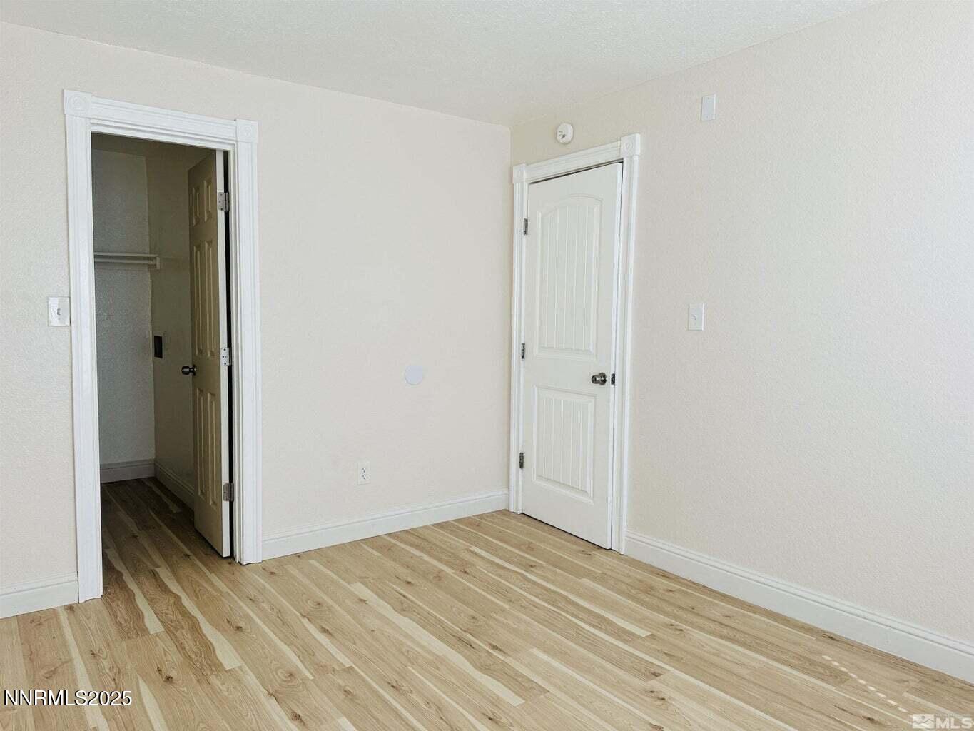 3927 Clear Acre Lane, Unit 207 Reno, NV 89512 - Photo 17 of 33 a view of empty room with wooden floor