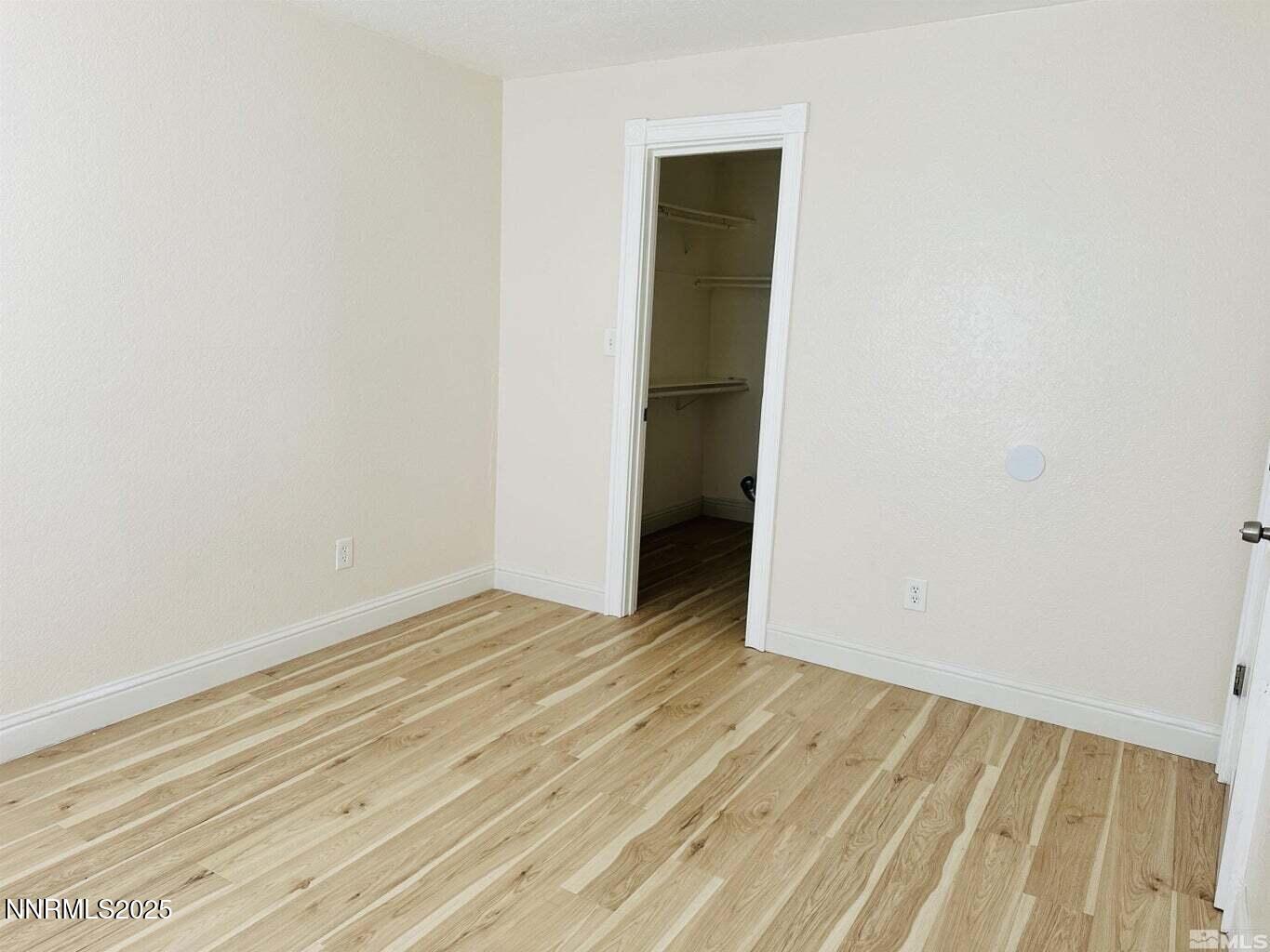 3927 Clear Acre Lane, Unit 207 Reno, NV 89512 - Photo 18 of 33 a view of an empty room with wooden floor and a window