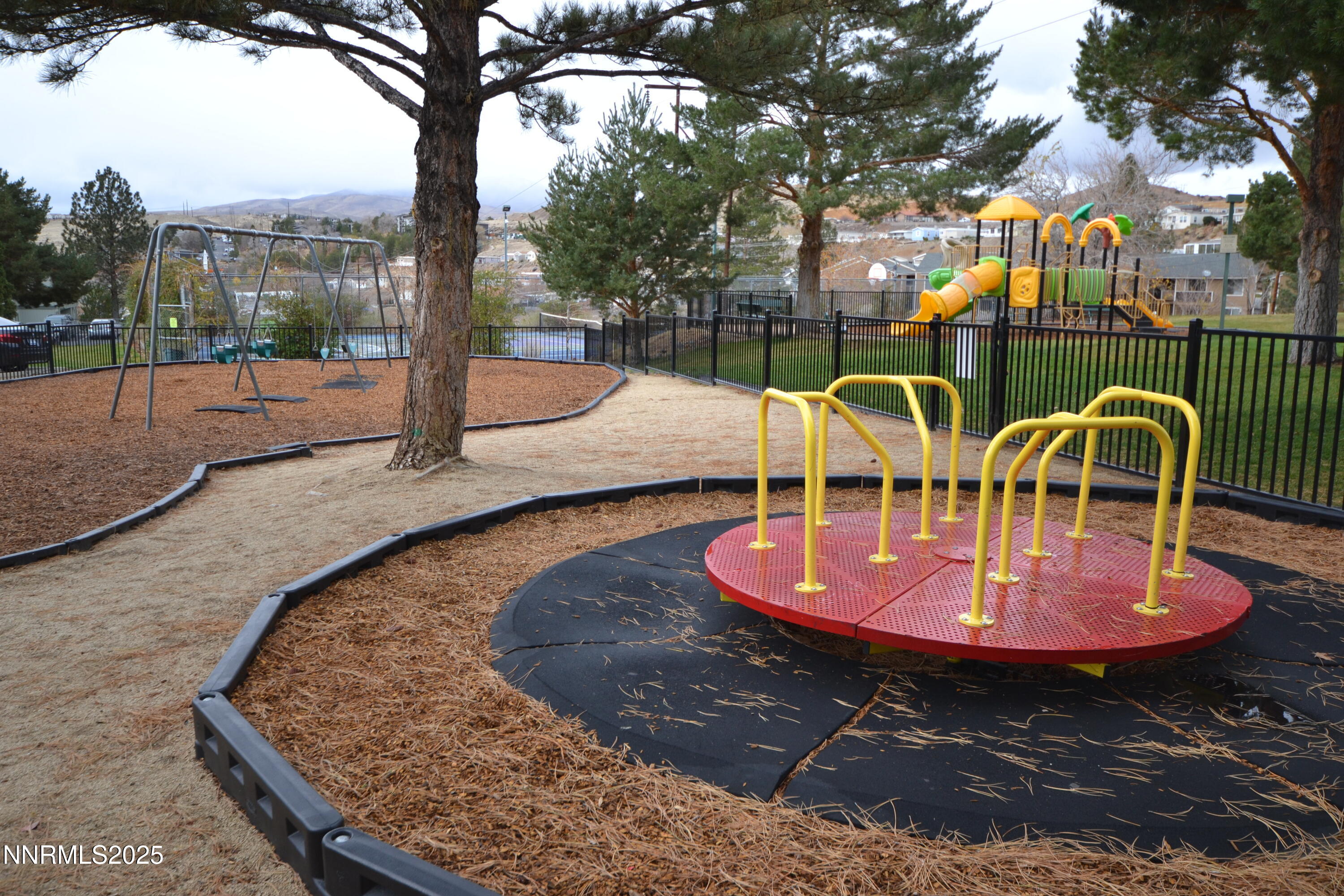 3927 Clear Acre Lane, Unit 207 Reno, NV 89512 - Photo 22 of 33 a backyard of a house with table and chairs