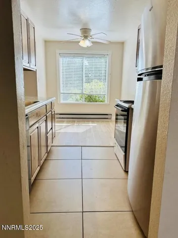 a kitchen with granite countertop a refrigerator a stove and a refrigerator