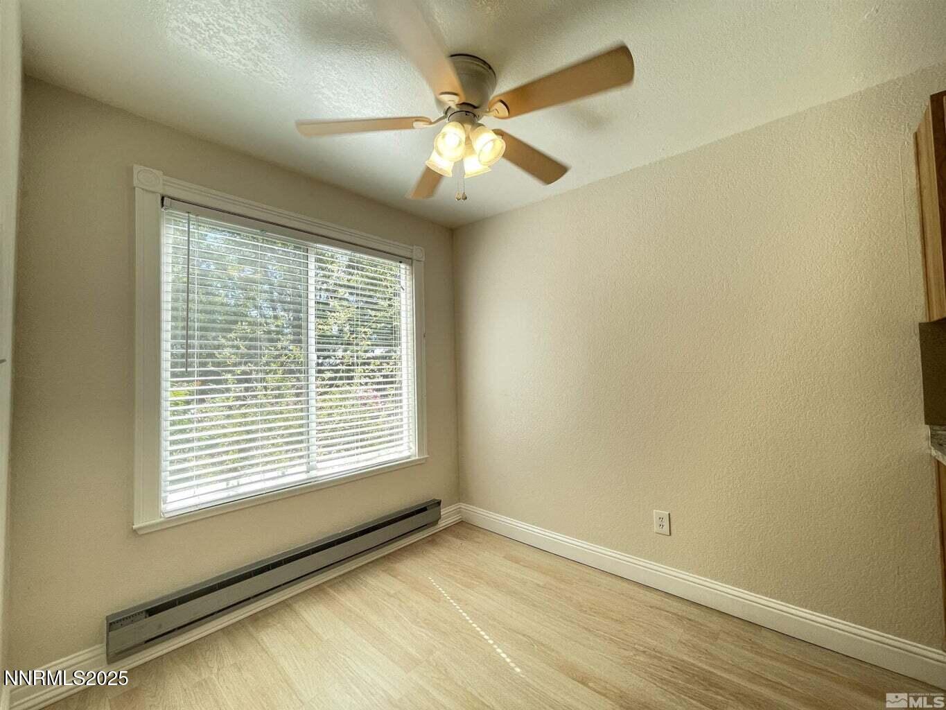 3927 Clear Acre Lane, Unit 207 Reno, NV 89512 - Photo 5 of 33 a view of an empty room with chandelier fan and fire place