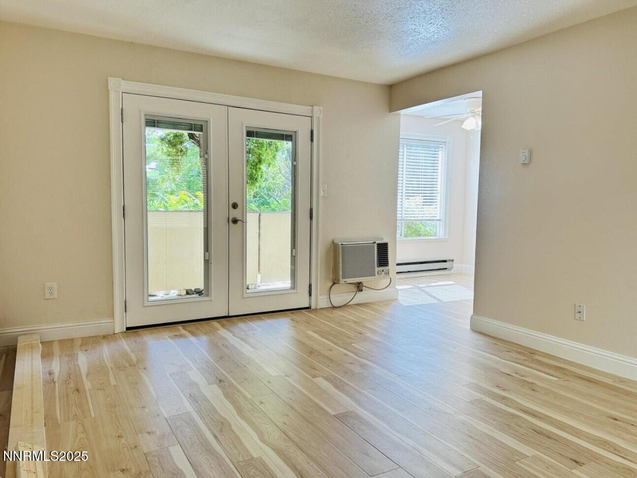 3927 Clear Acre Lane, Unit 207 Reno, NV 89512 - Photo 7 of 33 a view of an empty room with wooden floor and a window