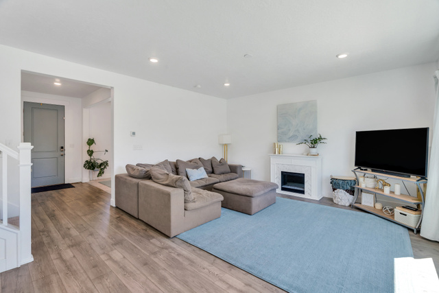 646 South Meade Street Mapleton, UT 84664 - Photo 7 of 46 Open-concept living area featuring wood-finish flooring, recessed lighting, and a modern fireplace with a detailed mantel
