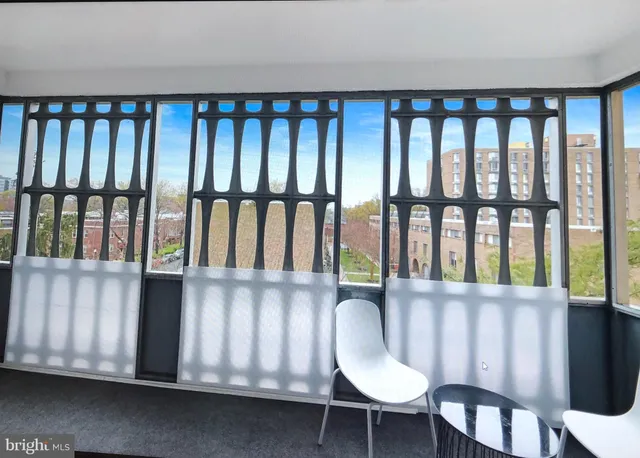 a view of a chairs and table in an empty room